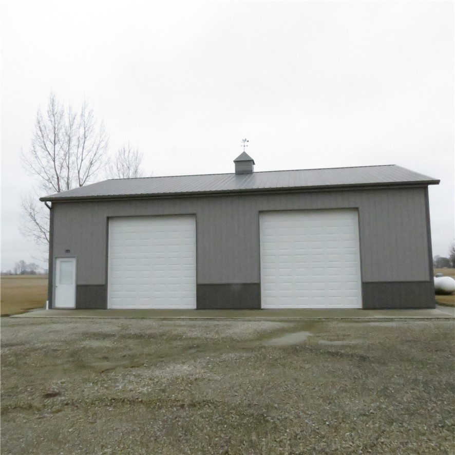 21242 Dingman-Slagle Road Pemberton, OH 45353 - Photo 3 of 33 This structure features multiple large garage doors and a weather vane, perfect for various uses.
