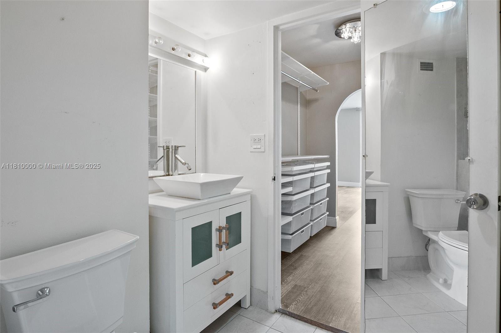 150 Southeast 25th Road, Unit 10K Miami, FL 33129 - Photo 16 of 43 a bathroom with a sink a toilet and a mirror