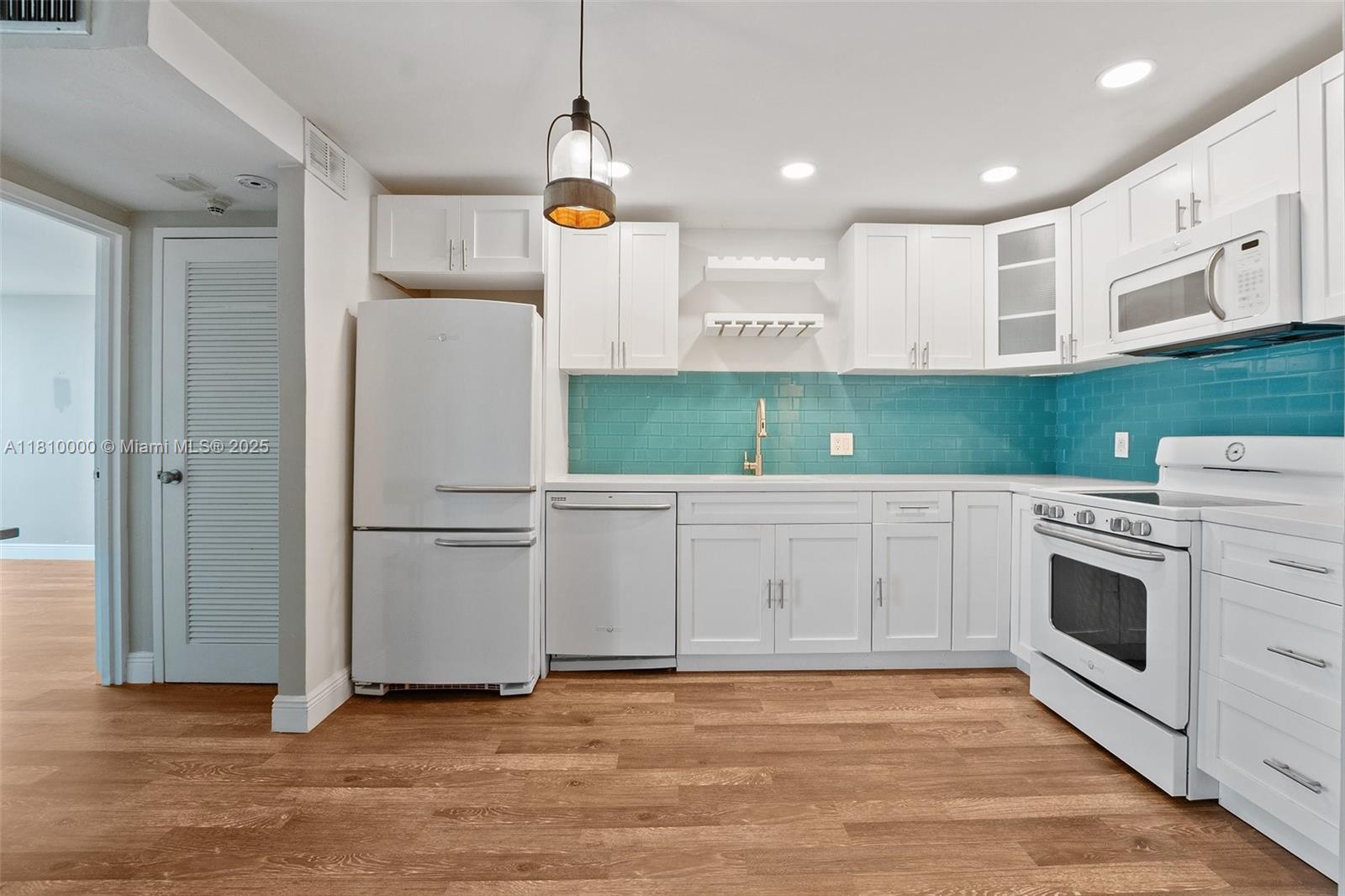 150 Southeast 25th Road, Unit 10K Miami, FL 33129 - Photo 5 of 43 a kitchen with a refrigerator a sink and cabinets