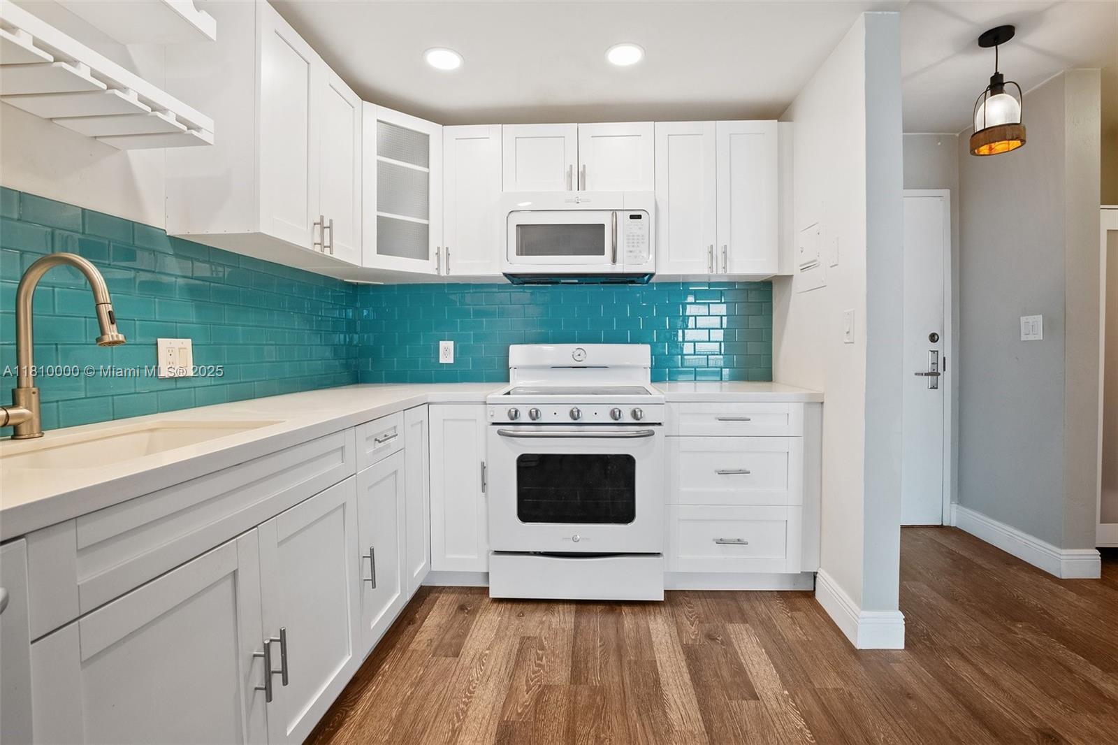 150 Southeast 25th Road, Unit 10K Miami, FL 33129 - Photo 6 of 43 a kitchen with stainless steel appliances white cabinets and a stove