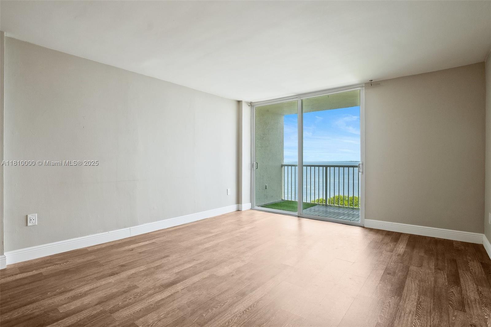150 Southeast 25th Road, Unit 10K Miami, FL 33129 - Photo 9 of 43 a view of an empty room with wooden floor and a window