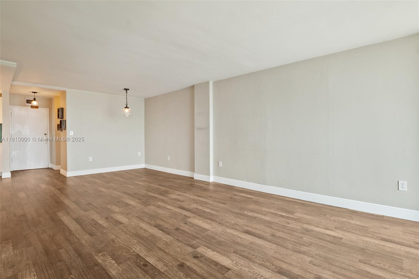 150 Southeast 25th Road, Unit 10K Miami, FL 33129 - Photo 10 of 43 a view of an empty room with wooden floor and a window