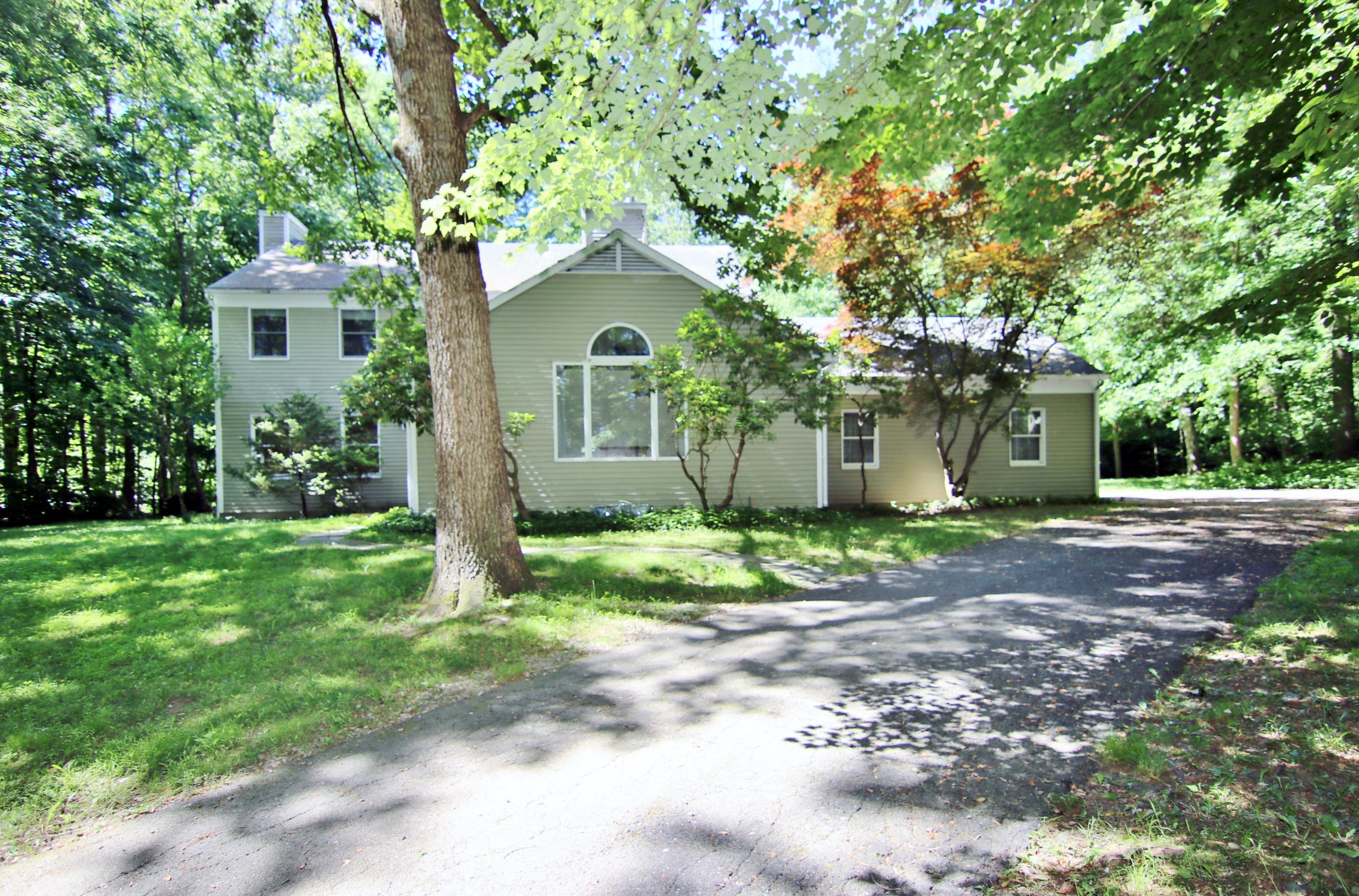 838 Valley Road New Canaan, CT 06840 - Photo 2 of 44 a front view of a house with garden