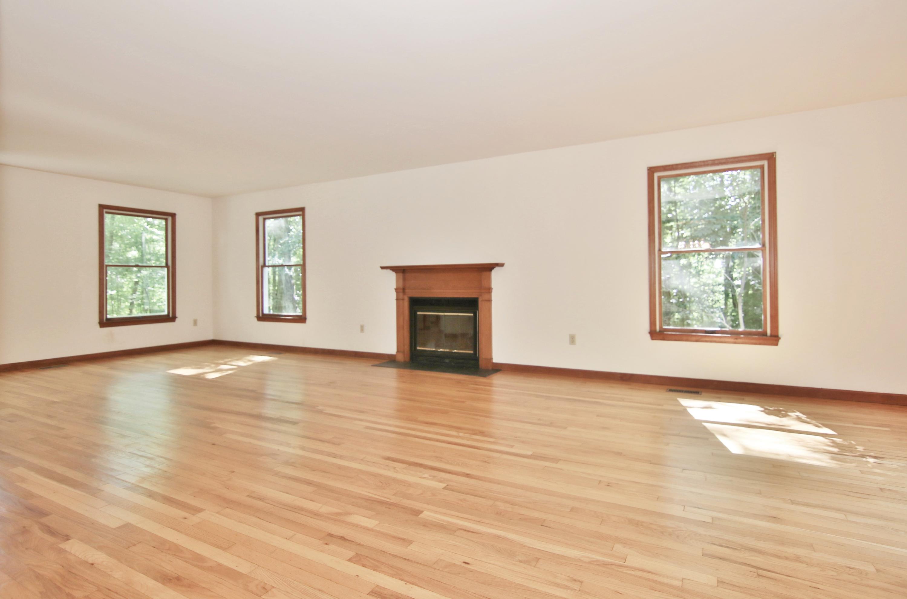 838 Valley Road New Canaan, CT 06840 - Photo 11 of 44 an empty room with wooden floor and windows