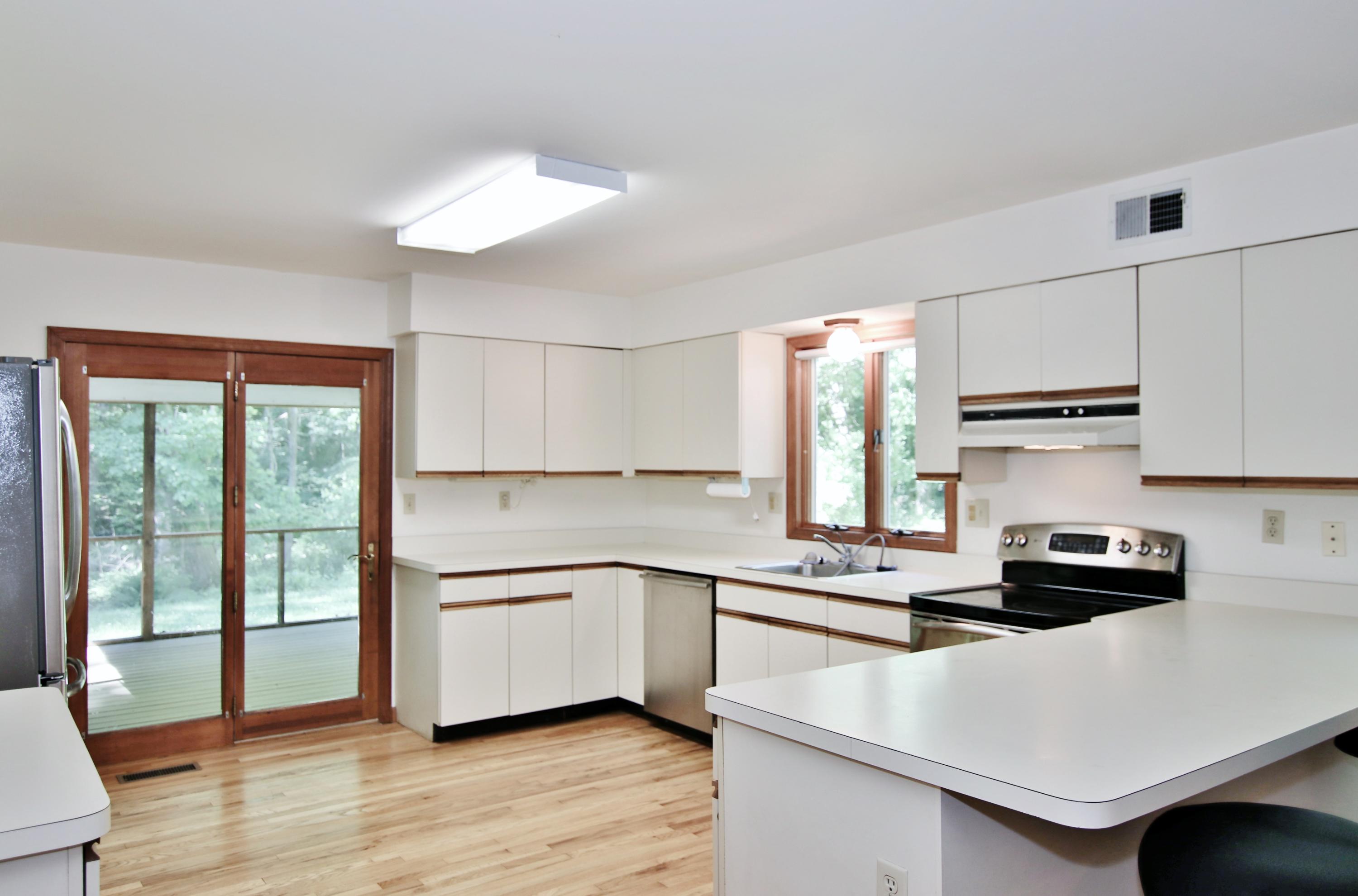 838 Valley Road New Canaan, CT 06840 - Photo 15 of 44 a kitchen with a sink a window and cabinets