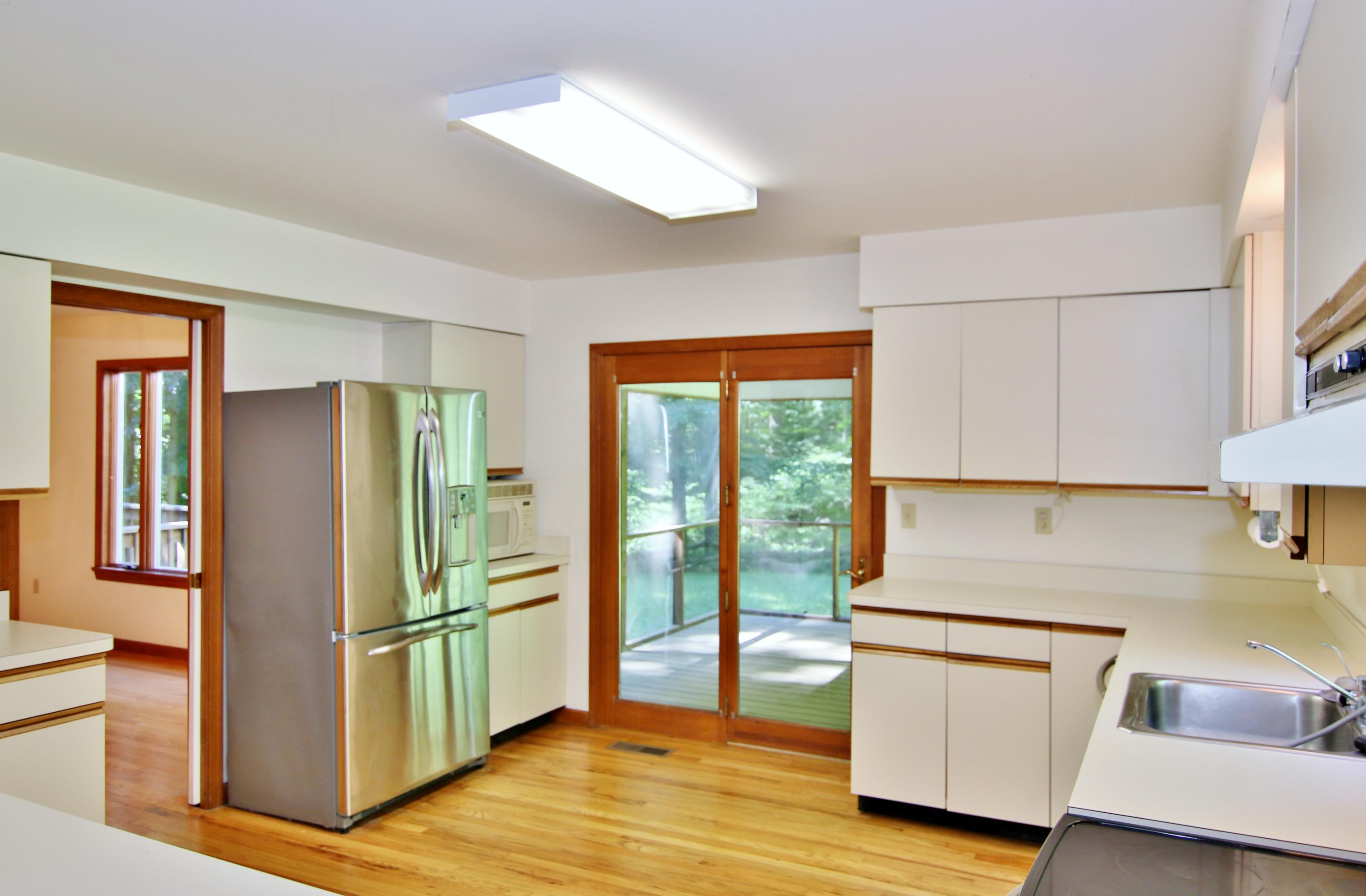 838 Valley Road New Canaan, CT 06840 - Photo 17 of 44 a kitchen with stainless steel appliances granite countertop a refrigerator a stove a sink and a large window