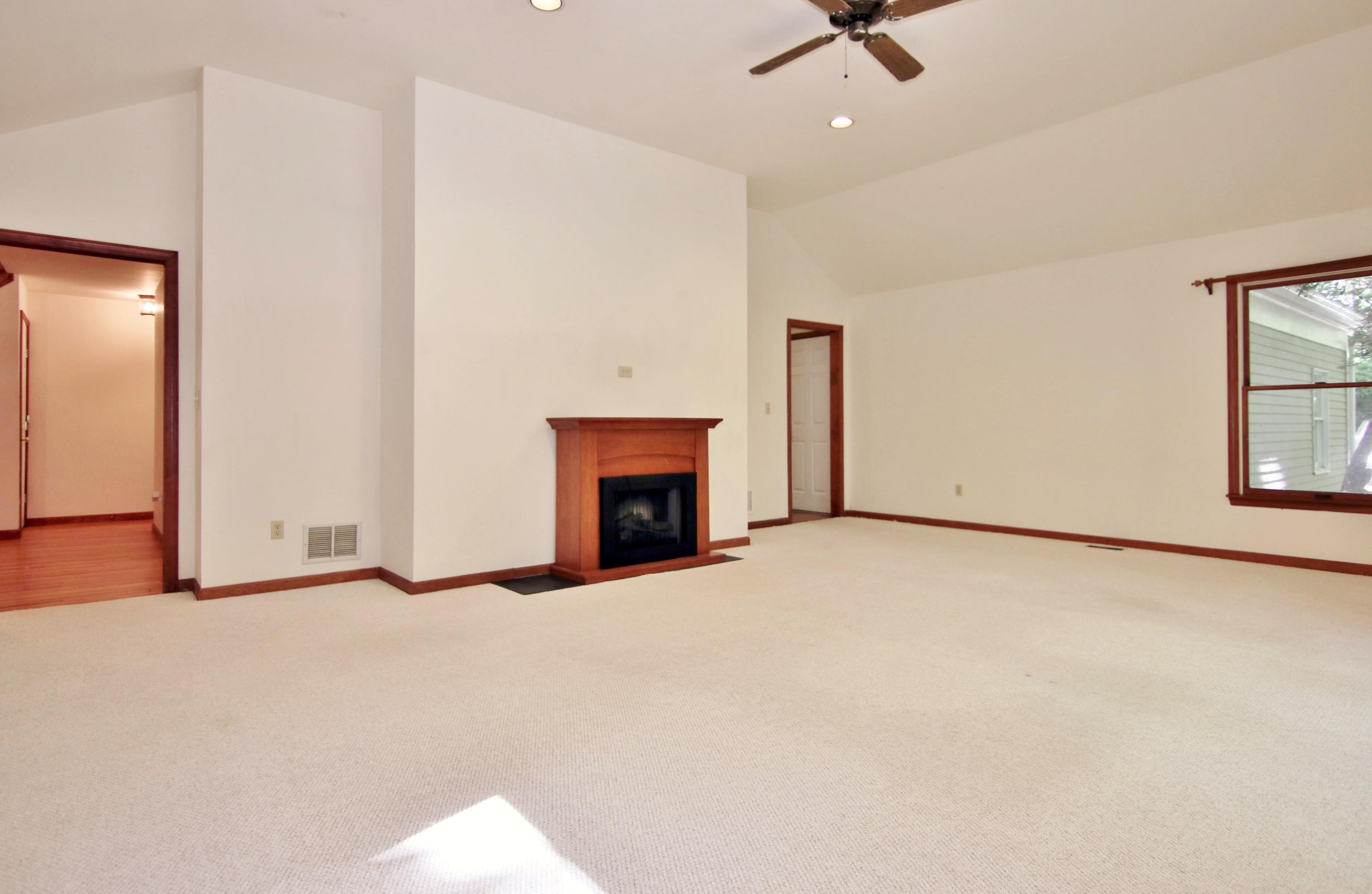 838 Valley Road New Canaan, CT 06840 - Photo 22 of 44 an empty room with windows and fireplace