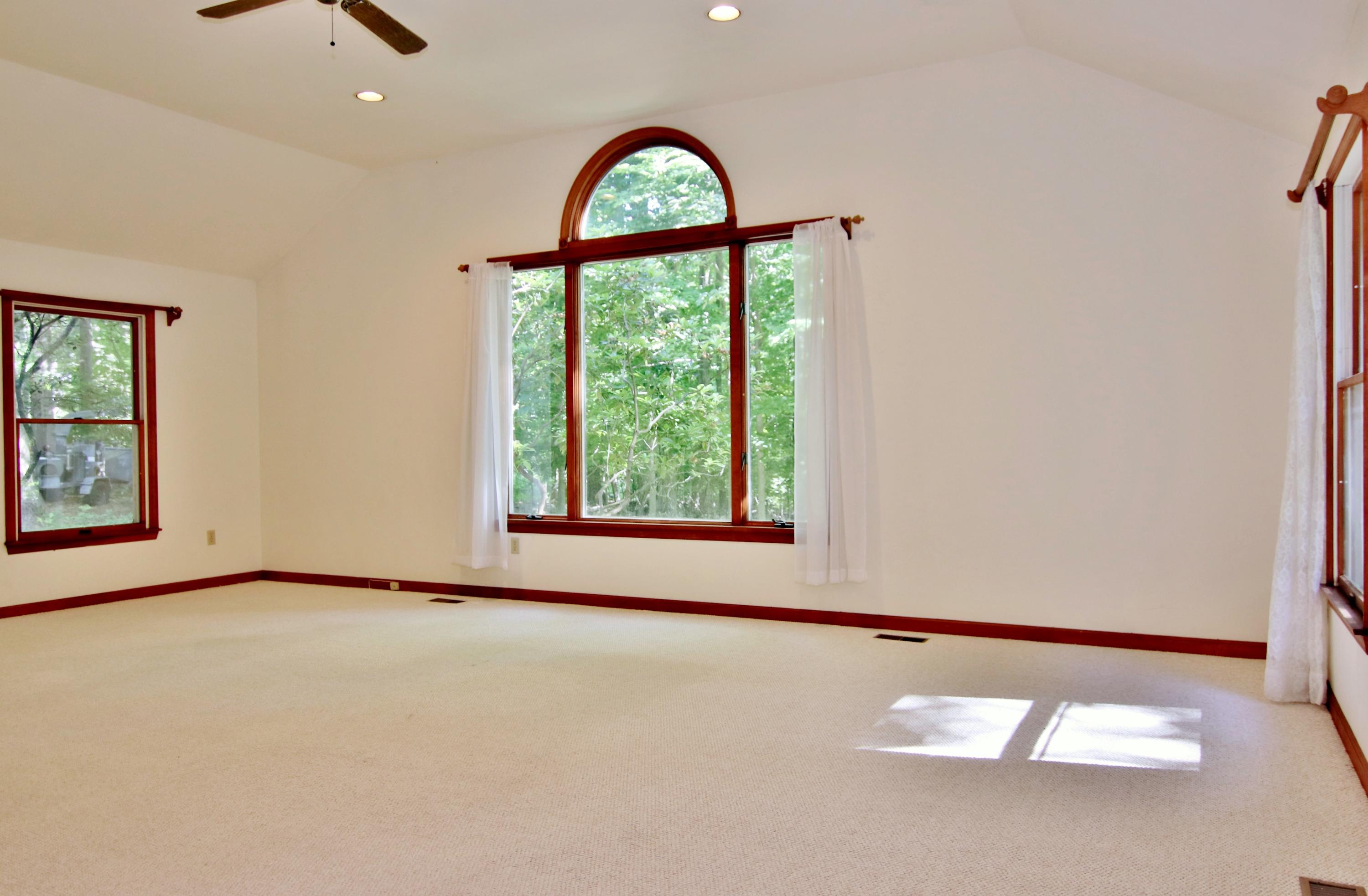 838 Valley Road New Canaan, CT 06840 - Photo 24 of 44 an empty room with windows and ceiling fan