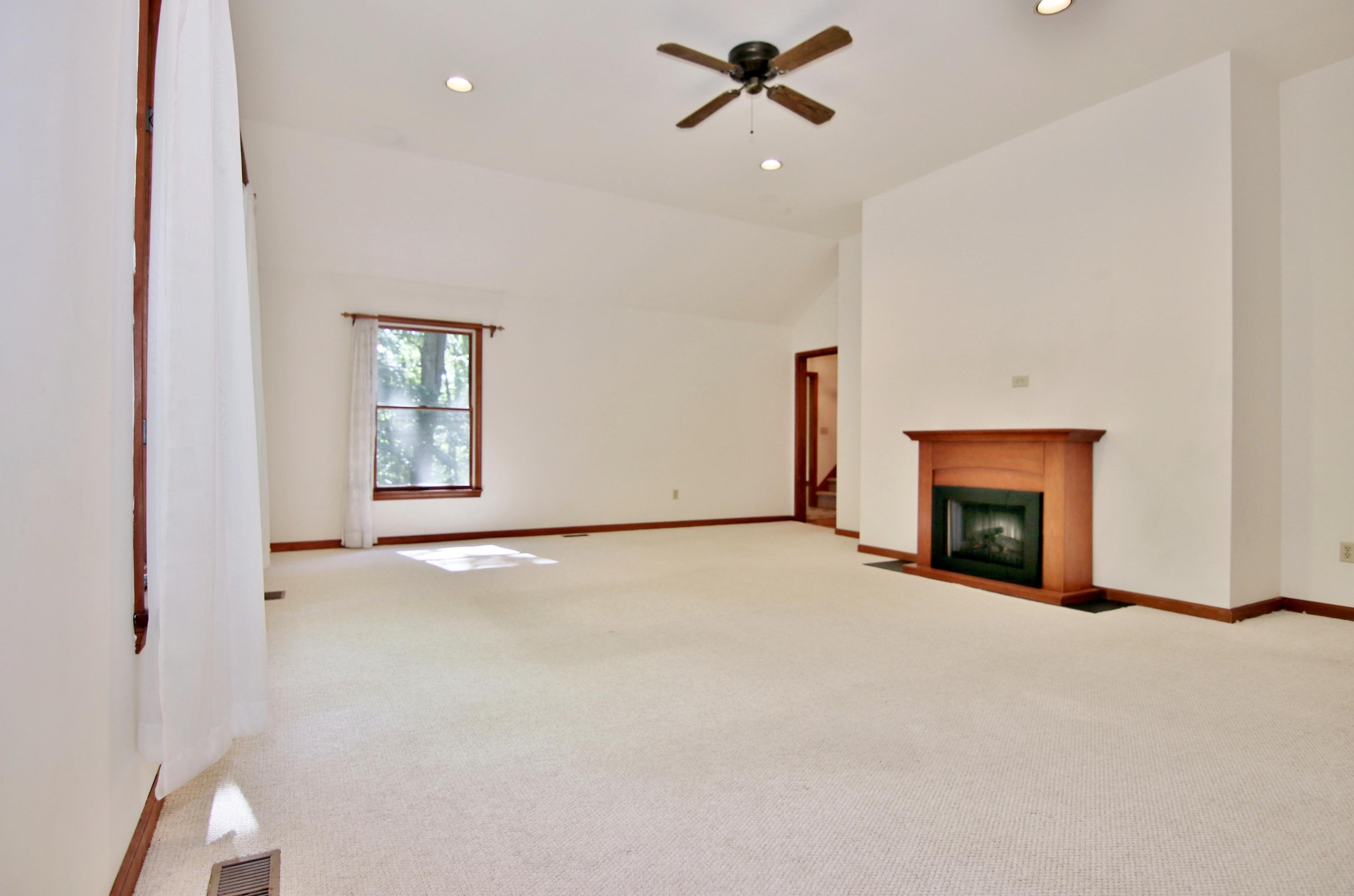 838 Valley Road New Canaan, CT 06840 - Photo 25 of 44 a view of an empty room with a fireplace and a window