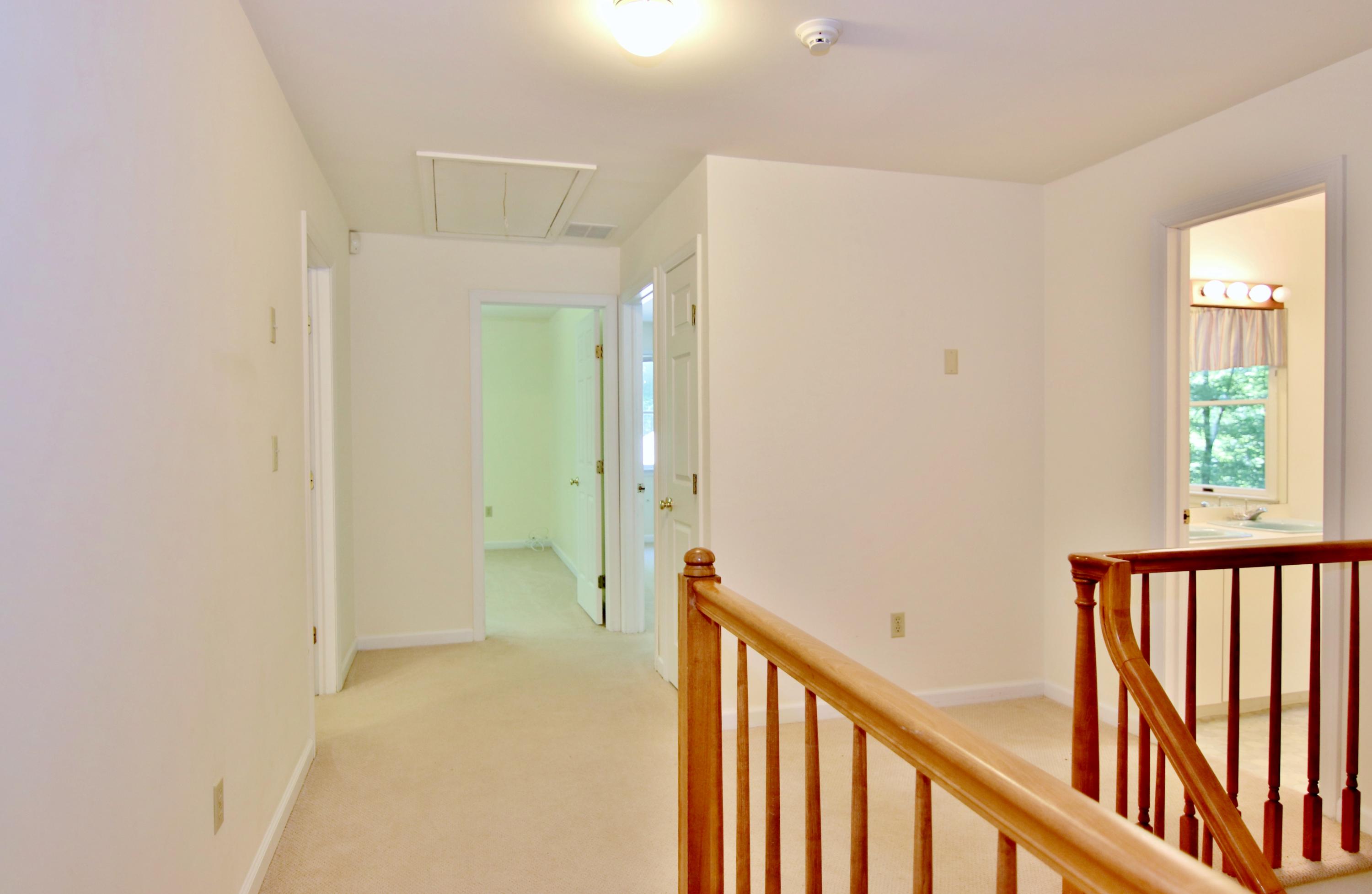 838 Valley Road New Canaan, CT 06840 - Photo 26 of 44 a view of a hallway with wooden floor and stairs
