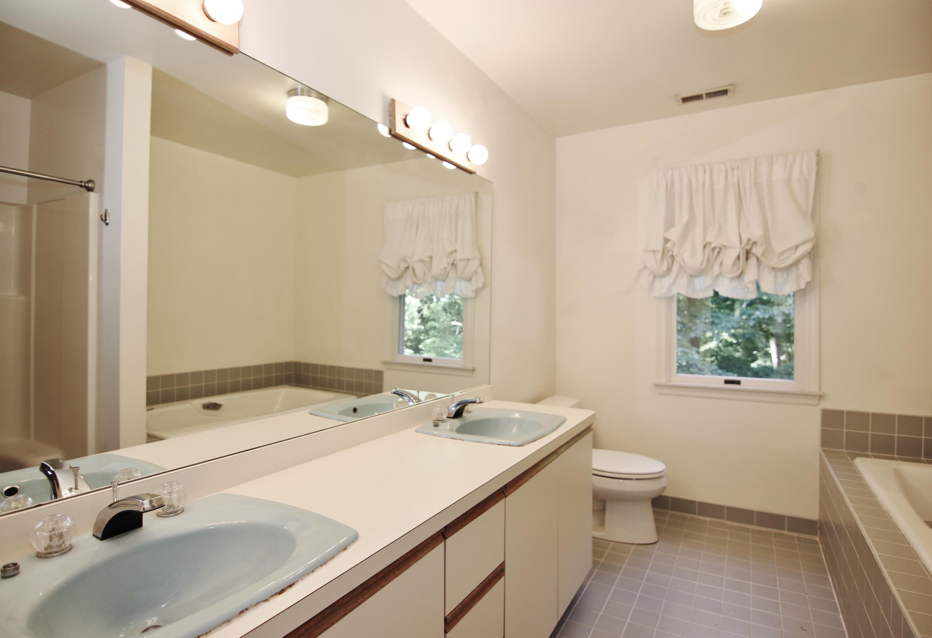 838 Valley Road New Canaan, CT 06840 - Photo 29 of 44 a bathroom with a sink a toilet and a mirror