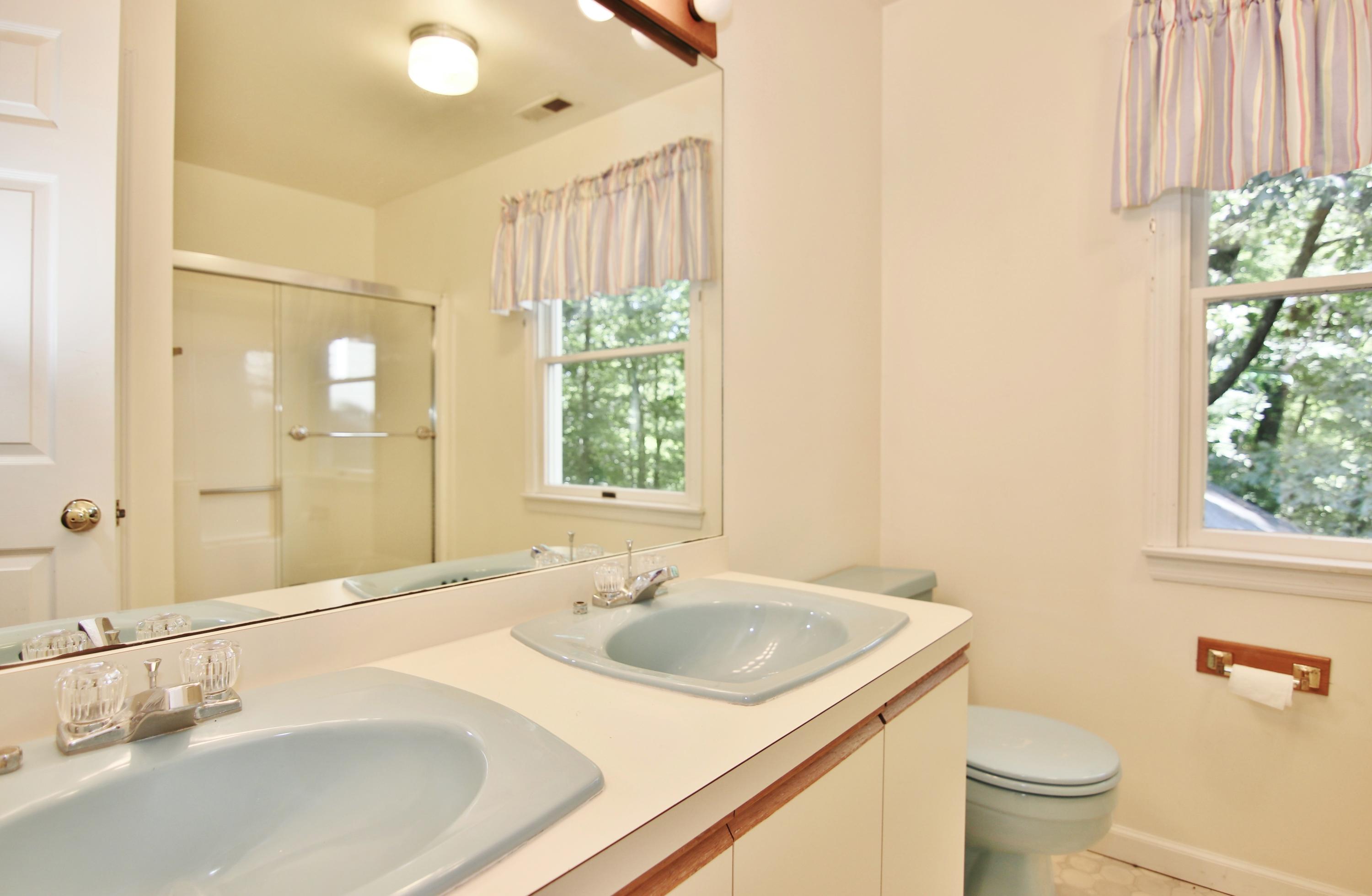 838 Valley Road New Canaan, CT 06840 - Photo 34 of 44 a bathroom with a sink and a mirror