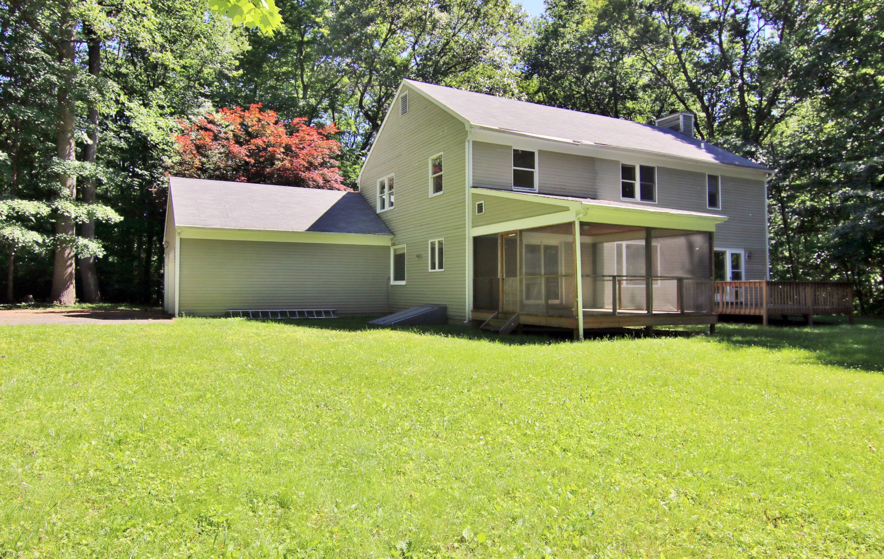 838 Valley Road New Canaan, CT 06840 - Photo 41 of 44 a front view of a house with a yard