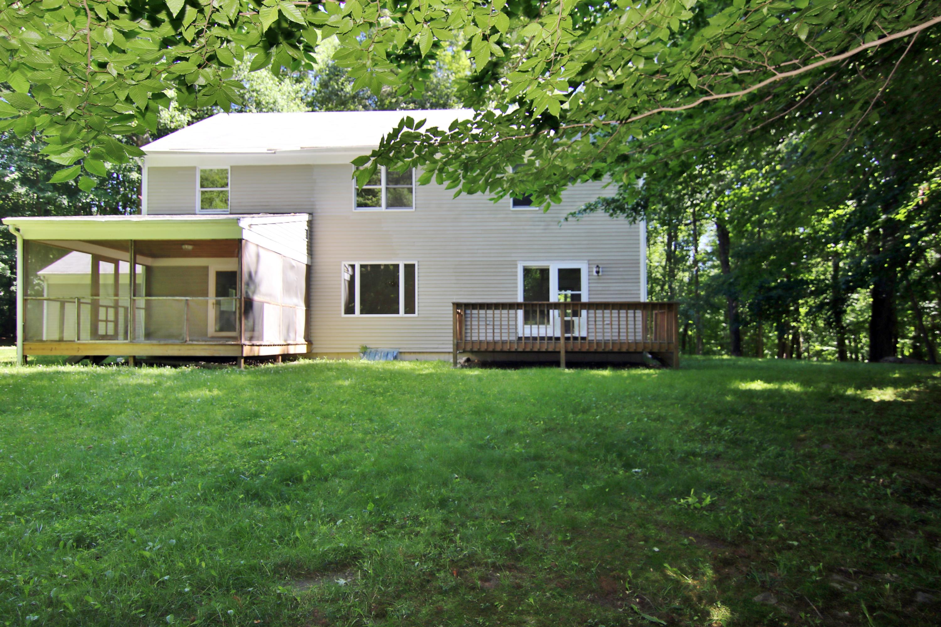 838 Valley Road New Canaan, CT 06840 - Photo 42 of 44 a front view of house with yard and green space