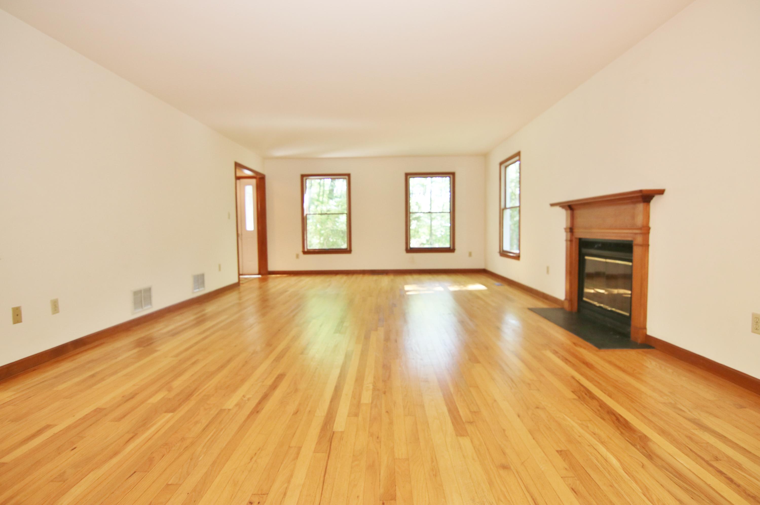 838 Valley Road New Canaan, CT 06840 - Photo 9 of 44 a view of an empty room with window and wooden floor