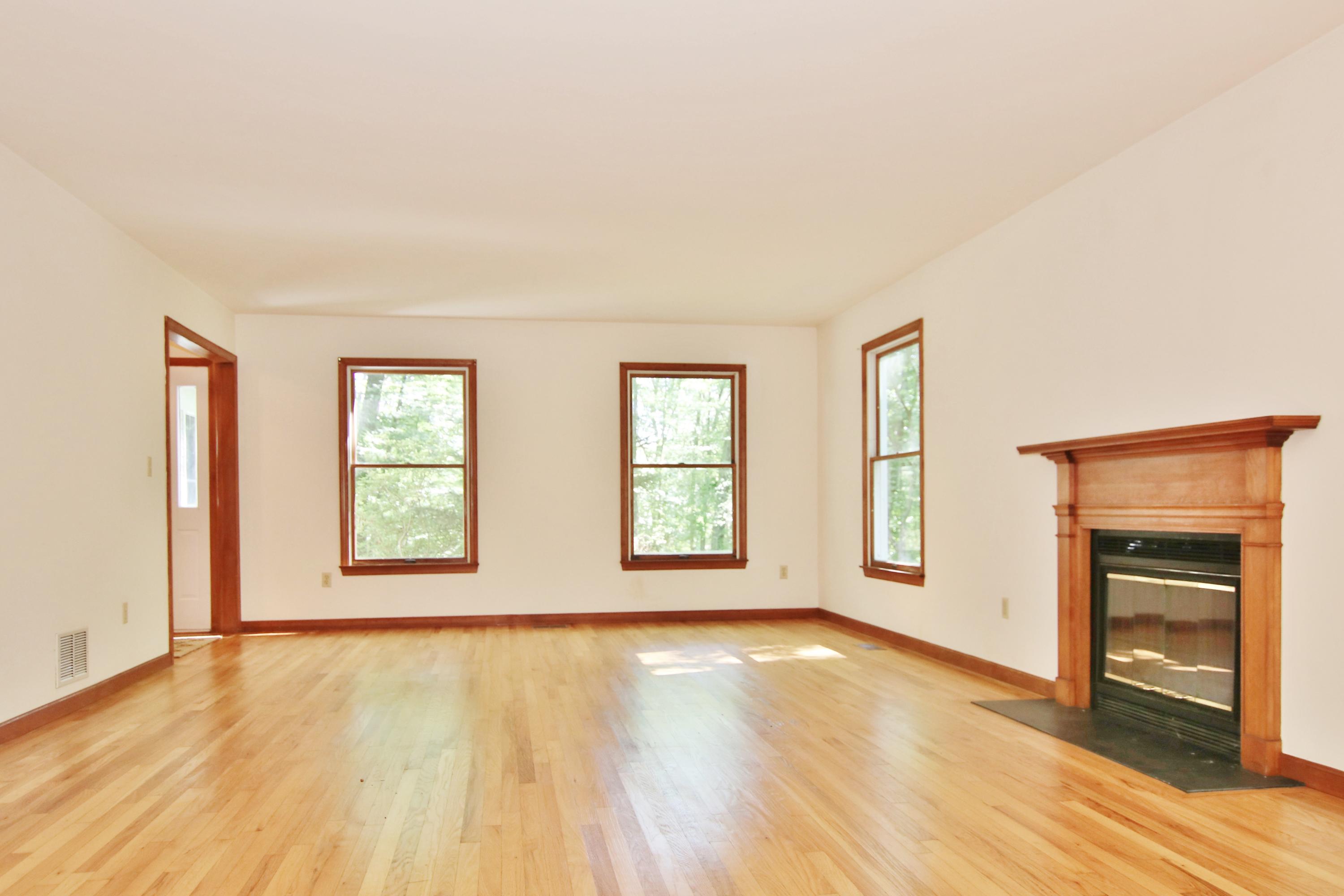 838 Valley Road New Canaan, CT 06840 - Photo 10 of 44 an empty room with wooden floor and windows