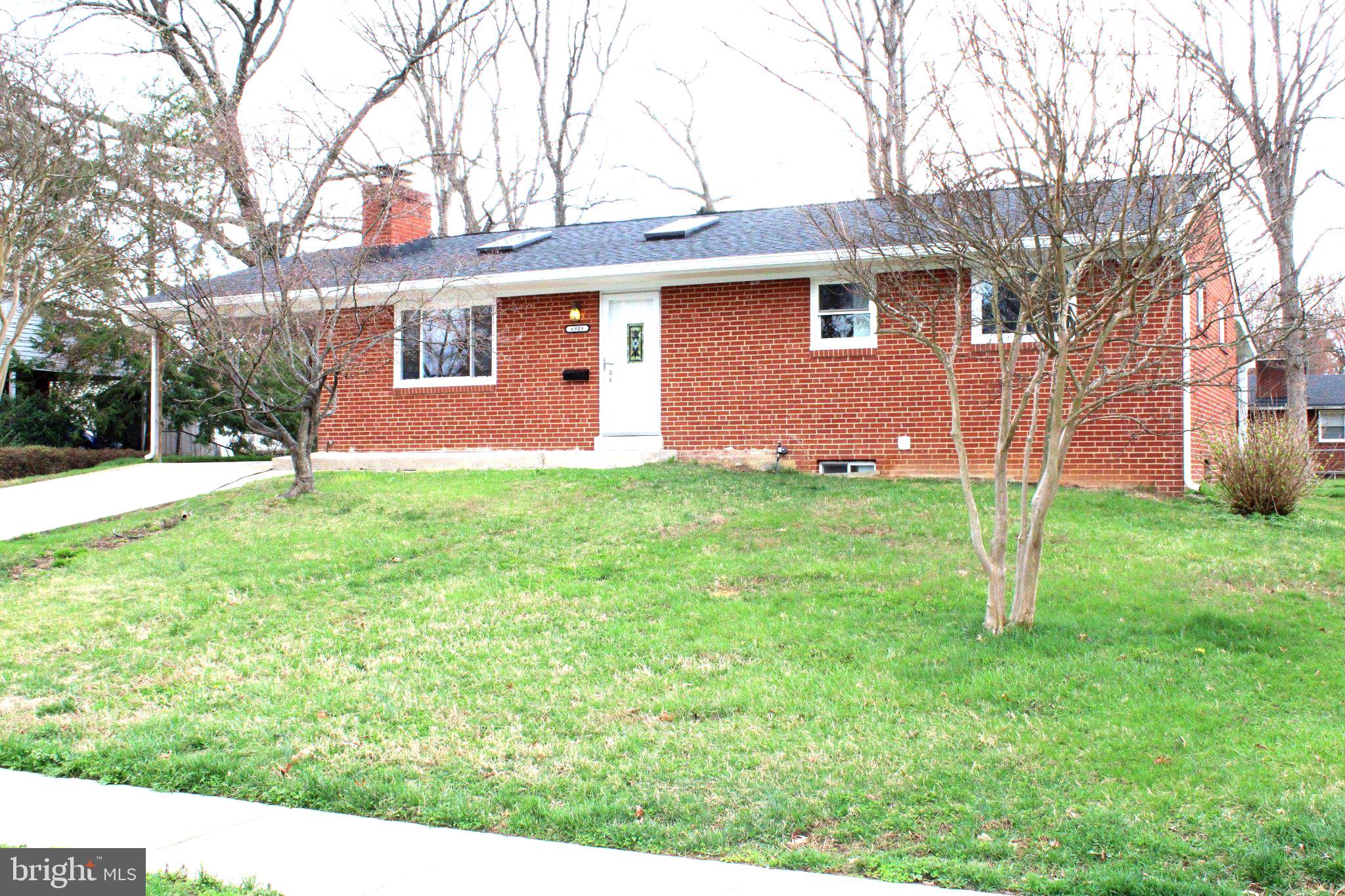 6809 Ruskin Street Springfield, VA 22150 - Photo 1 of 39 Charming brick home with lush lawn.
