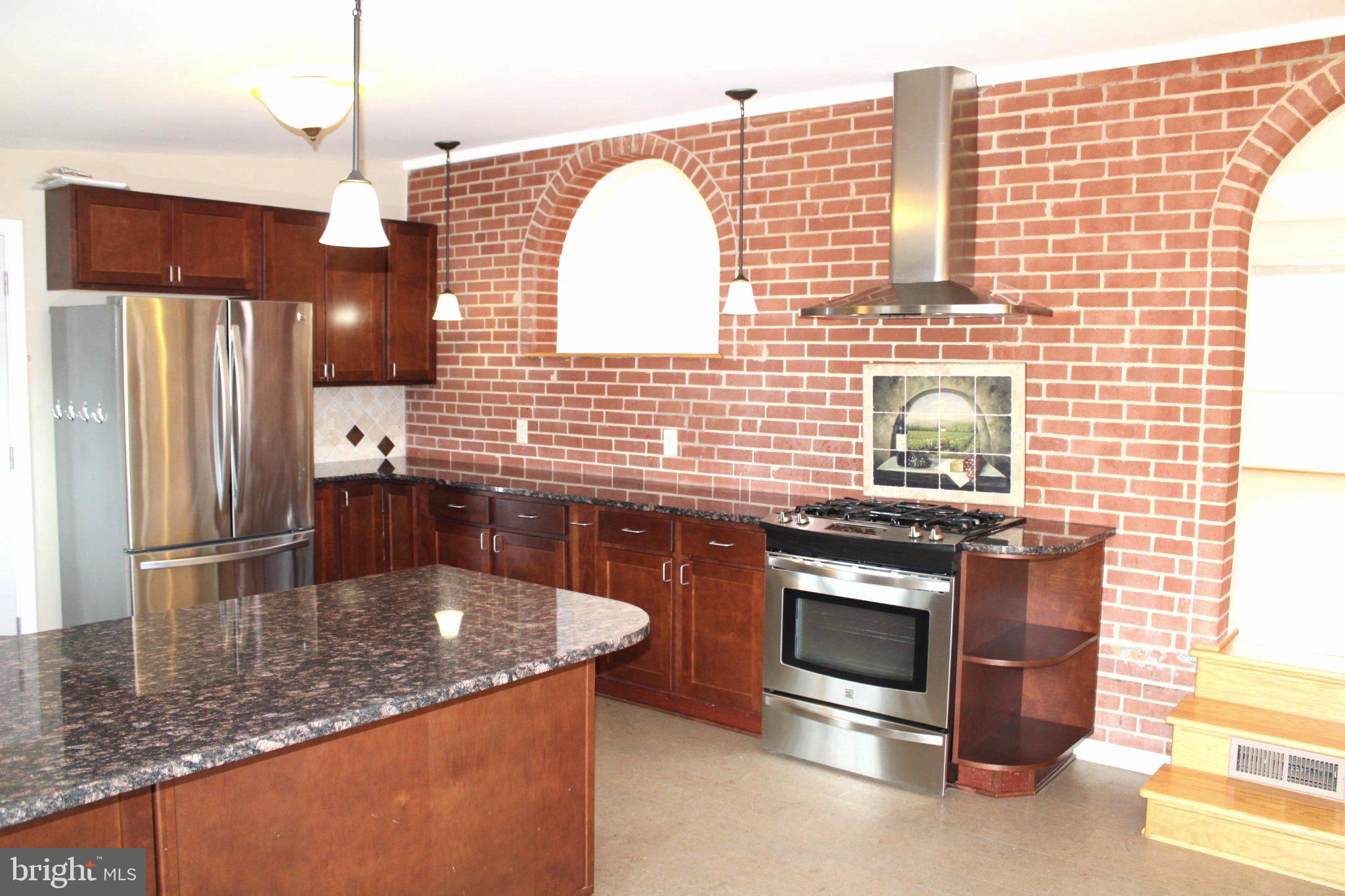 6809 Ruskin Street Springfield, VA 22150 - Photo 17 of 39 Charming kitchen with rustic brick accents.