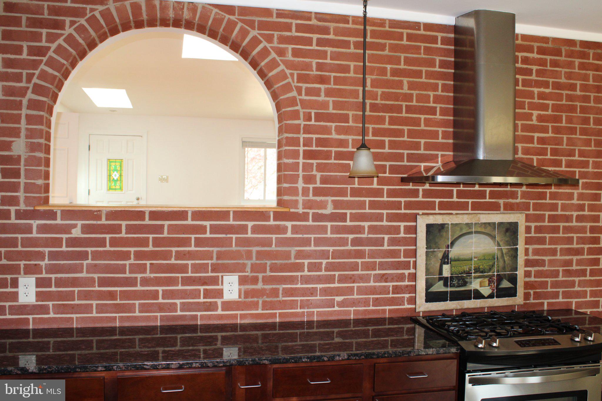 6809 Ruskin Street Springfield, VA 22150 - Photo 19 of 39 Charming brick kitchen with modern flair.