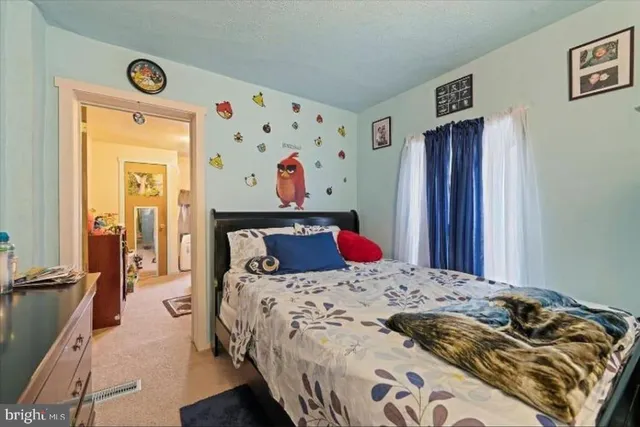 a bedroom with a bed and a dresser in it