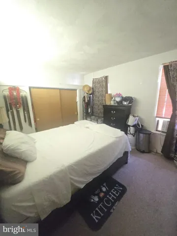 a spacious bedroom with a bed and a couch