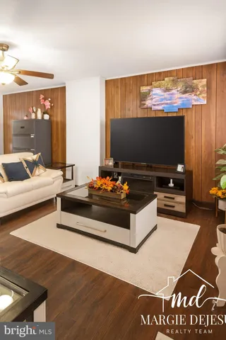 a living room with furniture and a flat screen tv