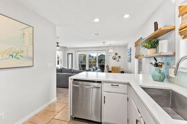 a view of a kitchen with a sink and a refrigerator
