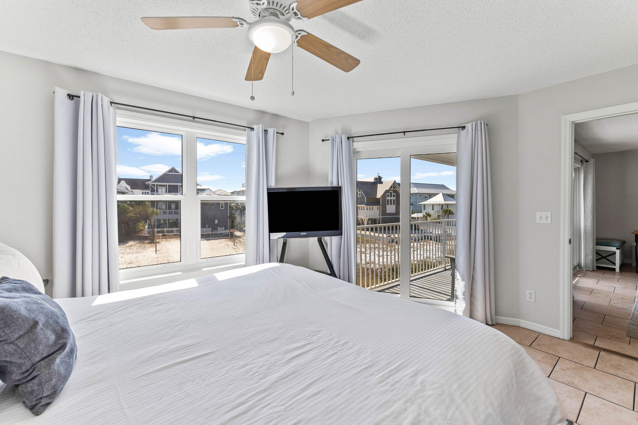 11 Beachside Drive, Unit 1121 Santa Rosa Beach, FL 32459 - Photo 19 of 43 a bedroom with a large bed and a flat tv screen next to a window