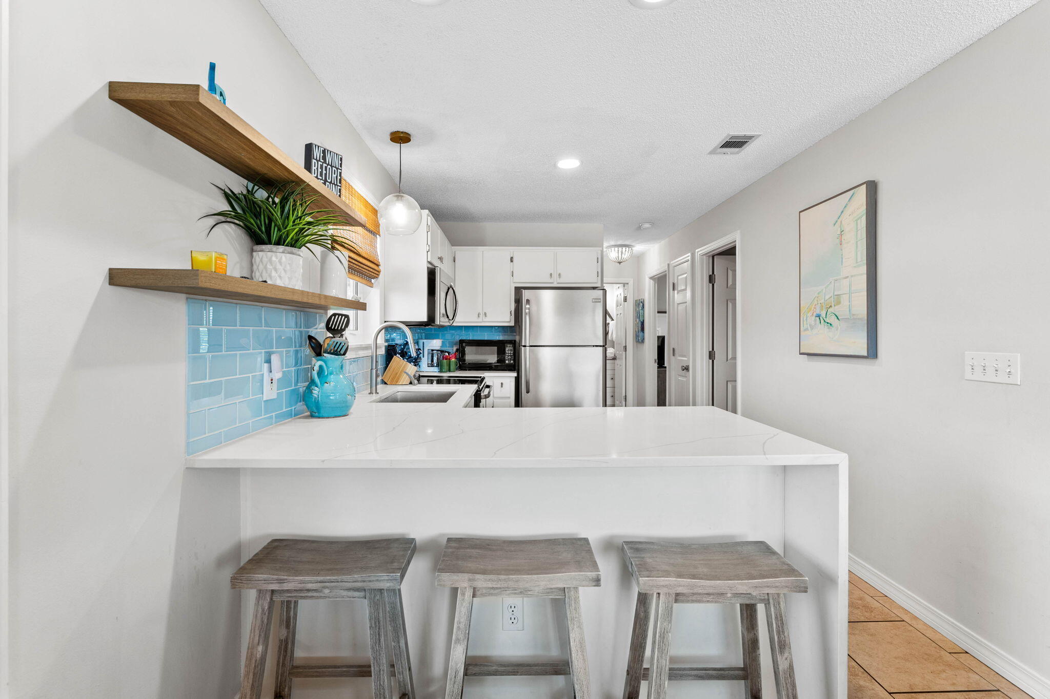 11 Beachside Drive, Unit 1121 Santa Rosa Beach, FL 32459 - Photo 8 of 43 a kitchen with kitchen island a stove a sink and a refrigerator