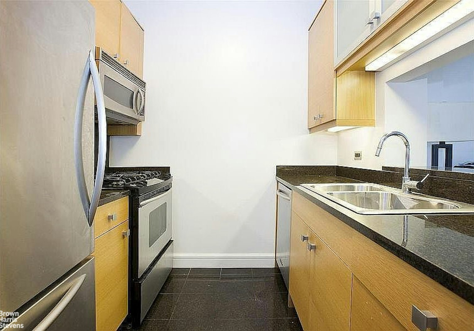 120 Riverside Boulevard, Unit 7H Manhattan, NY 10069 - Photo 4 of 6 a kitchen with a sink stove and refrigerator