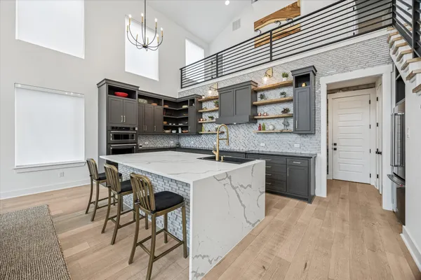 a kitchen with granite countertop a sink and a stove