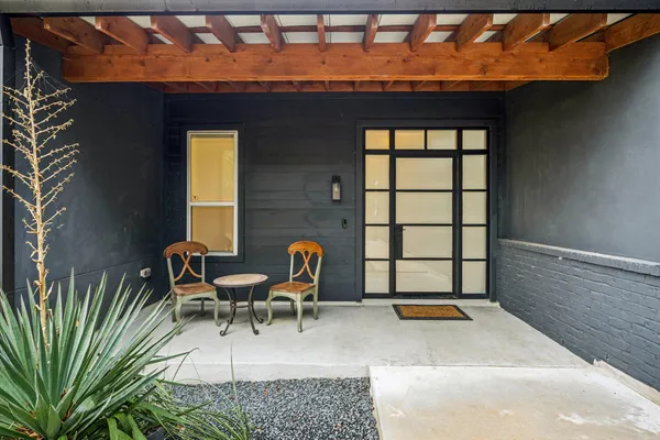 a balcony with table and chairs