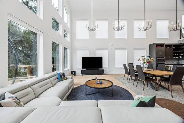 a living room with fireplace furniture and a large window