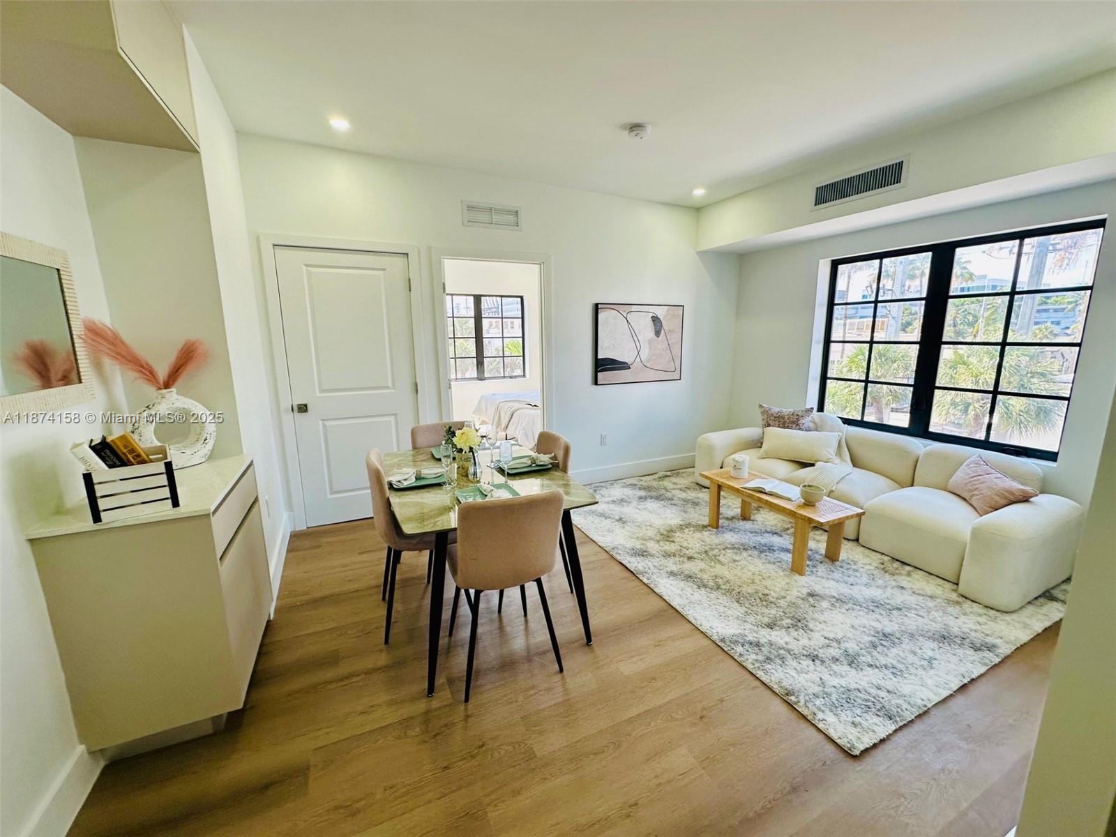 1619 Jefferson Avenue, Unit 103 Miami Beach, FL 33139 - Photo 4 of 8 a living room with furniture and a table