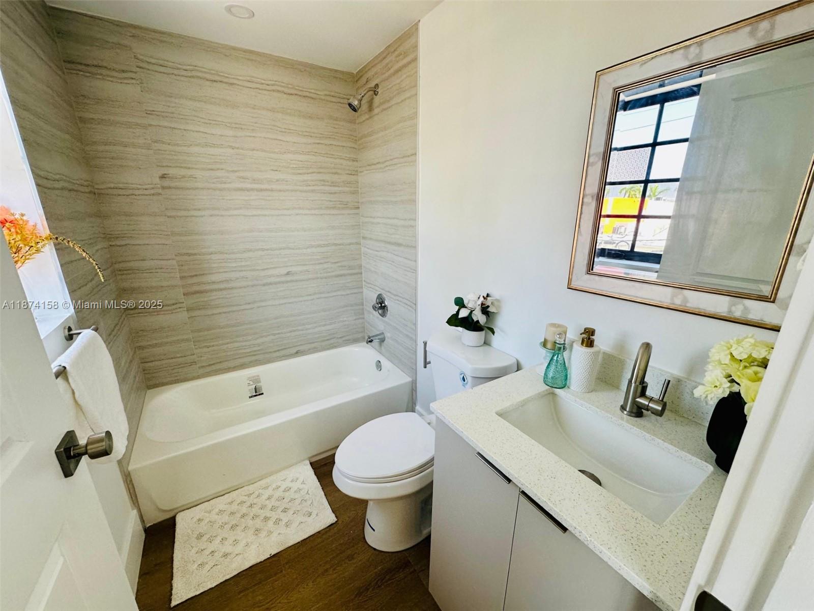 1619 Jefferson Avenue, Unit 103 Miami Beach, FL 33139 - Photo 6 of 8 a bathroom with a sink toilet and shower