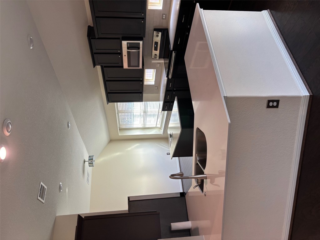 1421 Morning View Road Georgetown, TX 78628 - Photo 13 of 39 a kitchen with kitchen island a sink a stove a refrigerator a counter top space and cabinets