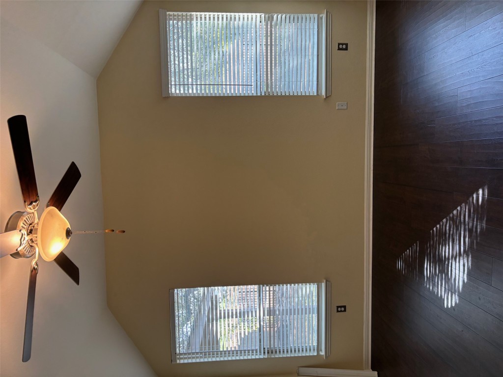 1421 Morning View Road Georgetown, TX 78628 - Photo 16 of 39 a view of an empty room with wooden floor and a window