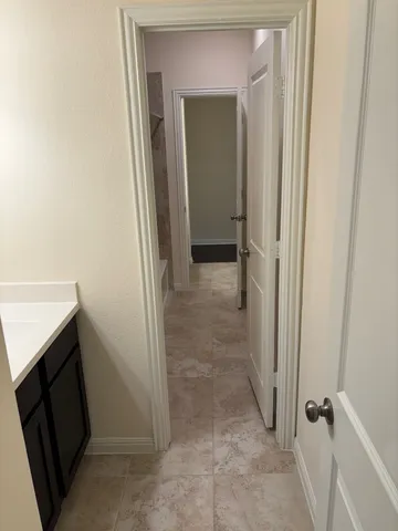 a view of a bathroom from a hallway