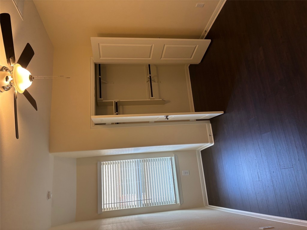 1421 Morning View Road Georgetown, TX 78628 - Photo 26 of 39 an empty room with wooden floor cabinet and windows