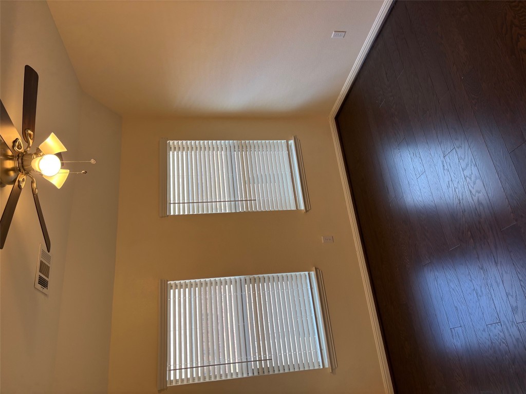 1421 Morning View Road Georgetown, TX 78628 - Photo 27 of 39 a view of an empty room with wooden floor and a window