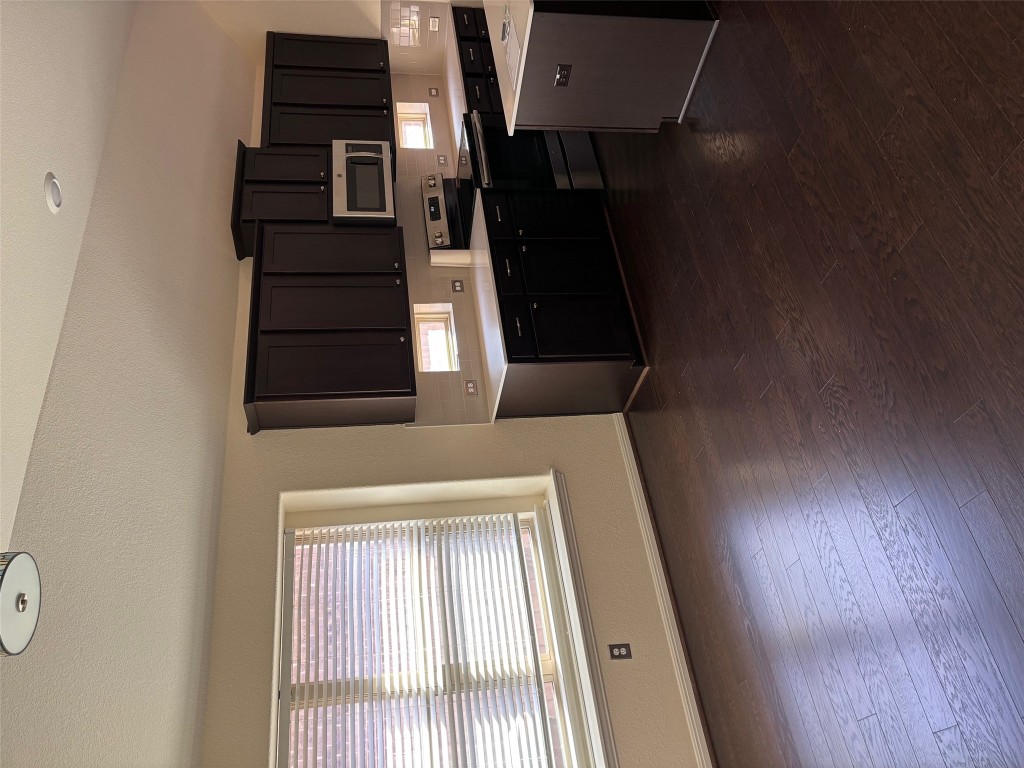 1421 Morning View Road Georgetown, TX 78628 - Photo 8 of 39 a kitchen with stainless steel appliances wooden cabinets and a stove top oven