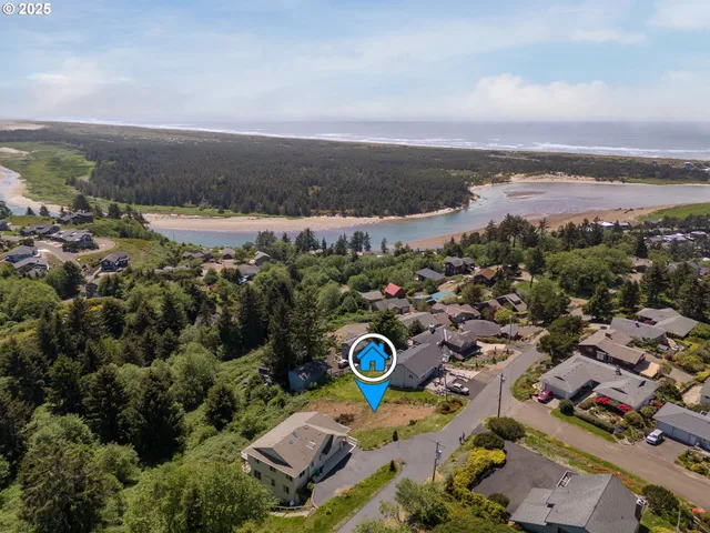 an aerial view of a city with lots of residential buildings and mountain view in back