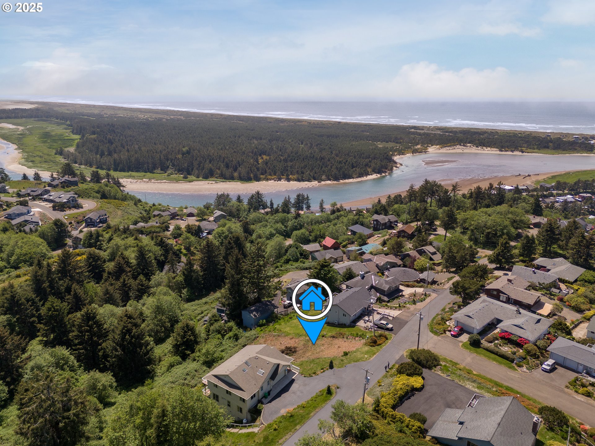 14901 East Summit Road Pacific City, OR 97135 - Photo 2 of 6 an aerial view of a city with lots of residential buildings and mountain view in back