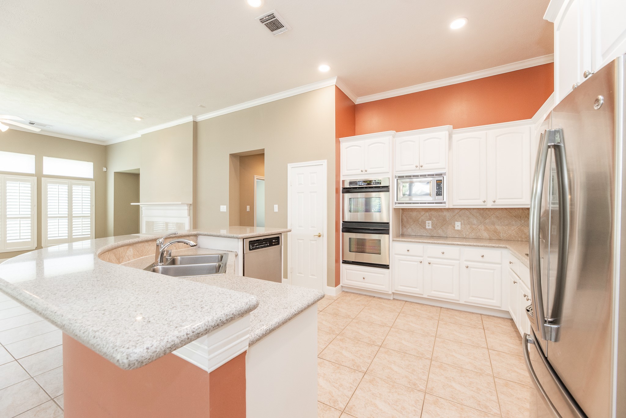 1222 Brinson Court Spring, TX 77379 - Photo 19 of 35 a kitchen with stainless steel appliances granite countertop a refrigerator and a sink