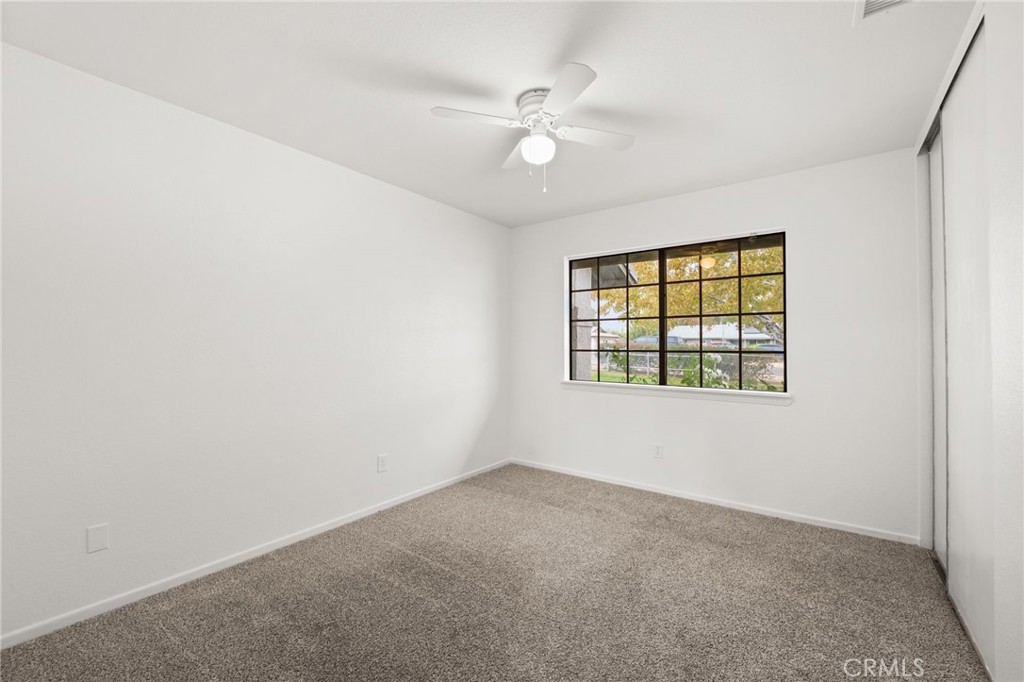 17805 Walnut Street Hesperia, CA 92345 - Photo 13 of 18 an empty room with windows and ceiling fan