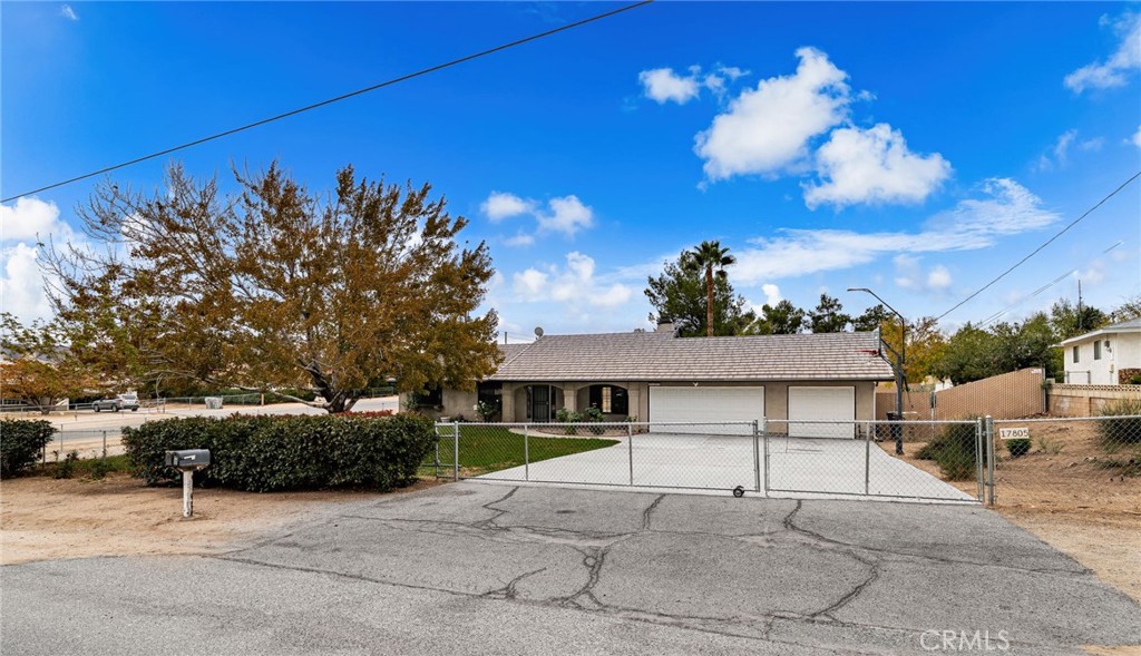 17805 Walnut Street Hesperia, CA 92345 - Photo 3 of 18 a front view of a house with a yard and garage