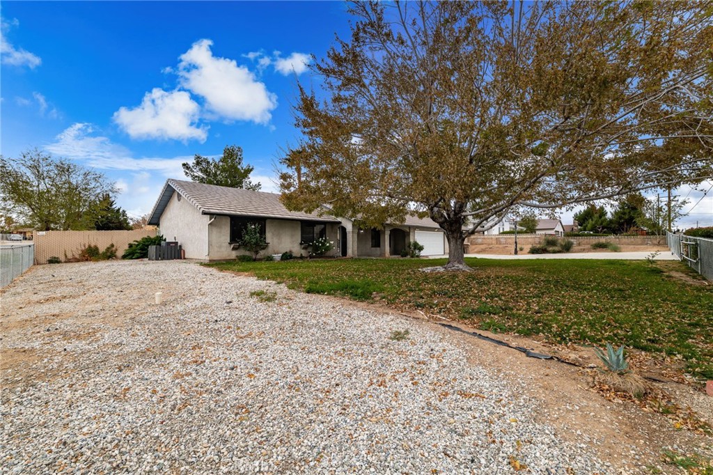 17805 Walnut Street Hesperia, CA 92345 - Photo 4 of 18 a front view of a house with a yard and garage