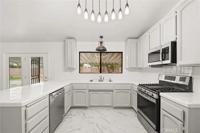 a kitchen with a sink stove and microwave