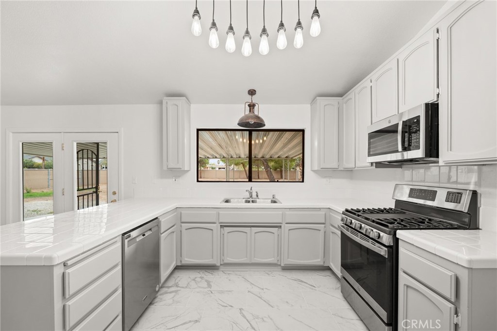 17805 Walnut Street Hesperia, CA 92345 - Photo 7 of 18 a kitchen with a sink stove and microwave