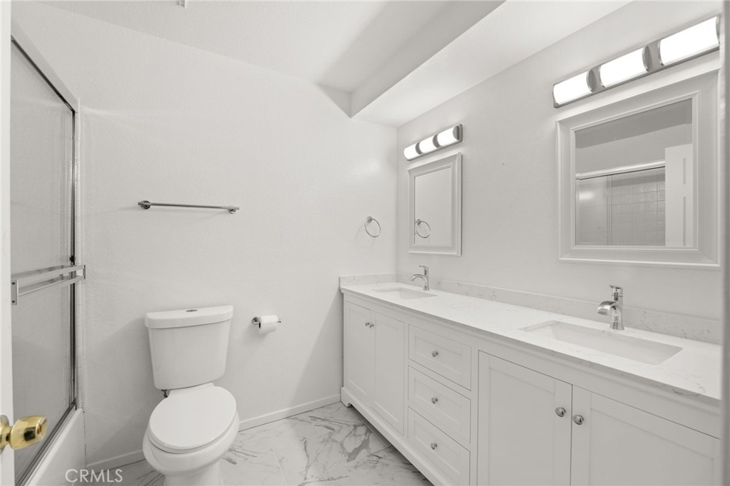 17805 Walnut Street Hesperia, CA 92345 - Photo 10 of 18 a bathroom with a toilet a sink a mirror and vanity